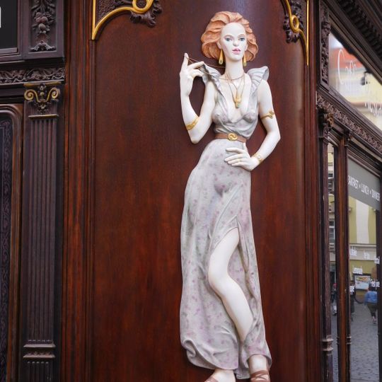 Relief of a woman on the corner of Husova and Karlova streets