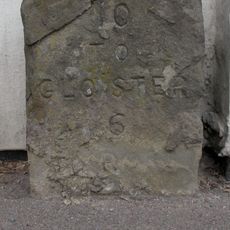 Milestone Against Garden Wall Of Hopebrook