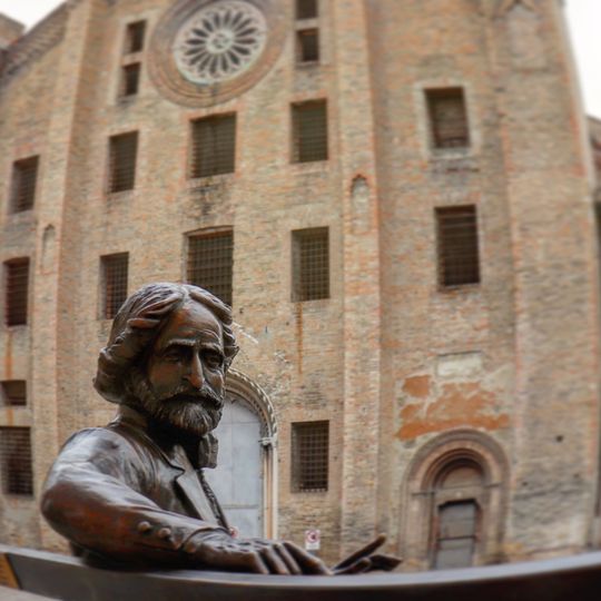 Statue of Giuseppe Verdi sitting on a bench