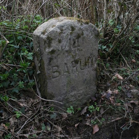 Milestone, 250m NW of minor road to village, 50m N of lay-by