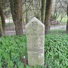 Milestone, W of road to Shipton Gorge;