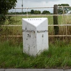 Milepost, E of Fox Road jct, opp public house car Park