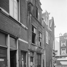 Pand met gepleisterde trapgevel, versierd met natuursteen blokken