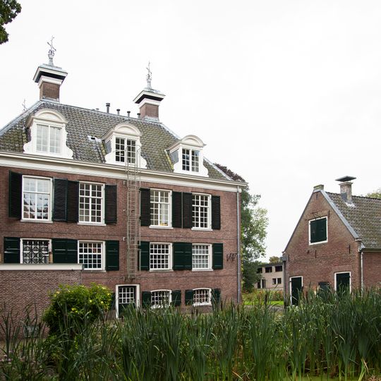 Lage woning met topgevel, 18e eeuw, tuinmuur; gesmeedijzeren hek.