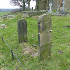 Stocks in graveyard of Church of St Thomas the Apostle