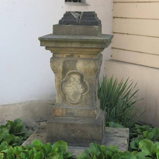 Podstavec s vylomeným křížem u kostela svatých Petra a Pavla v Bílíně