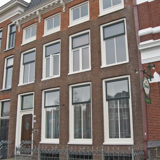 Vier traveeën breed pand met hek langs stoep