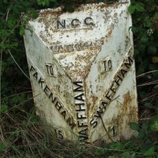 Milepost, Castle Acre Road, by Safeway store,