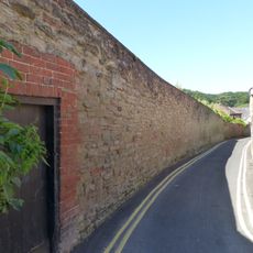 Wall to western part of south side of lane