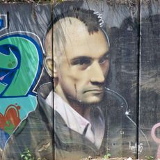 Grafiti mural de Robert De Niro caracterizado como Travis Bickle.