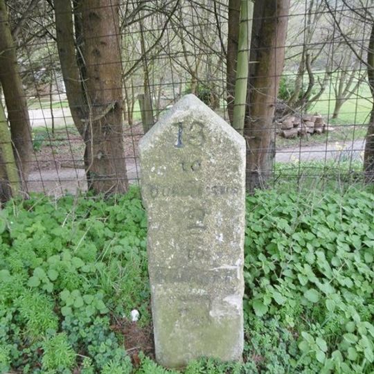 Milestone, W of road to Shipton Gorge;