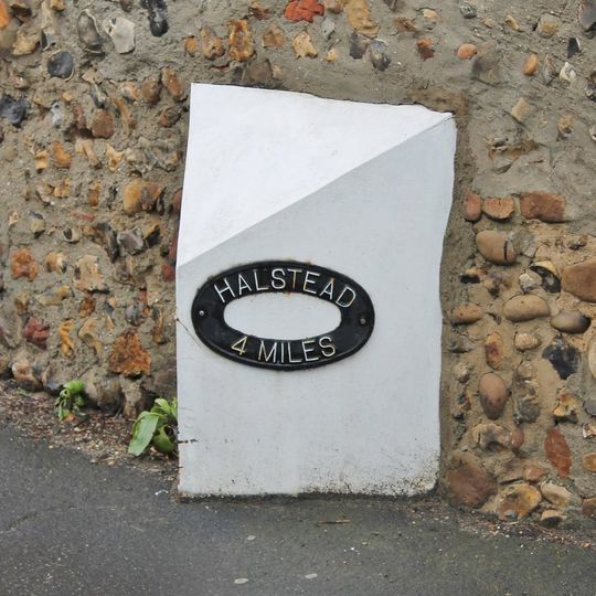 Milepost, opposite Church