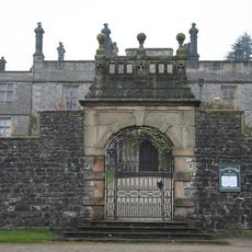 Gate piers, walls and entrance gateway and gates to Hall