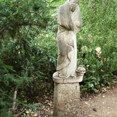 Figure Of Elderly Man In Poets Walk At Anglesey Abbey