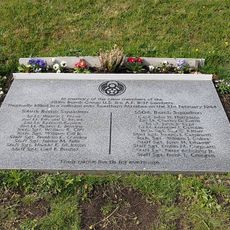 Engraved marble plaque set in ground on slope overlooking Reedham Marshes.