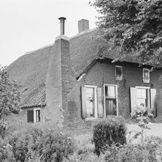 Boerderij onder rieten wolfdak met in de voorgevel jaartalankers