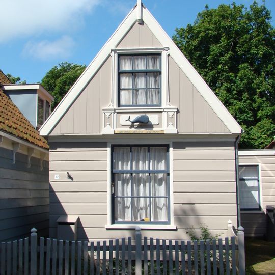 Houten huis met in de topgevel een vensteromlijsting