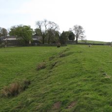 Carvoran Roman fort and Hadrian's Wall and vallum between the unclassified road to Old Shield and the field boundary west of the fort in wall miles 45 and 46