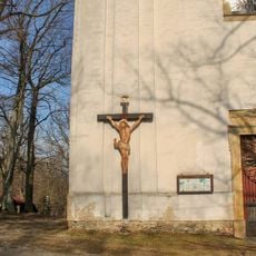 Wooden cross in Vysoké Žibřidovice by the church wall