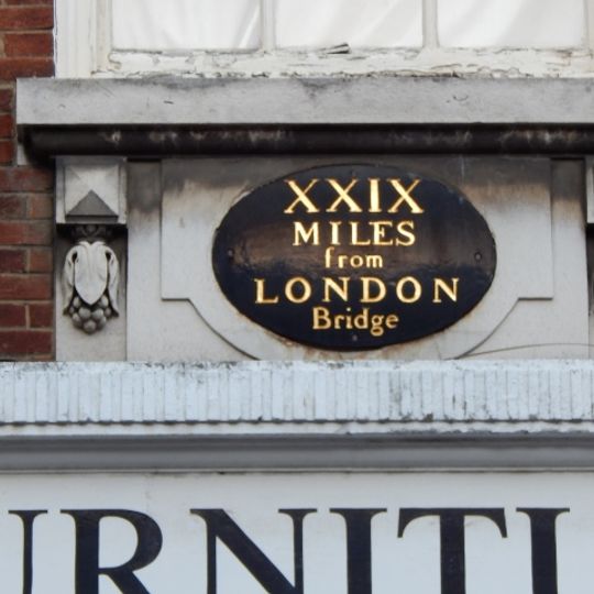 Milestone, High Street, on No. 25, N of George Lane