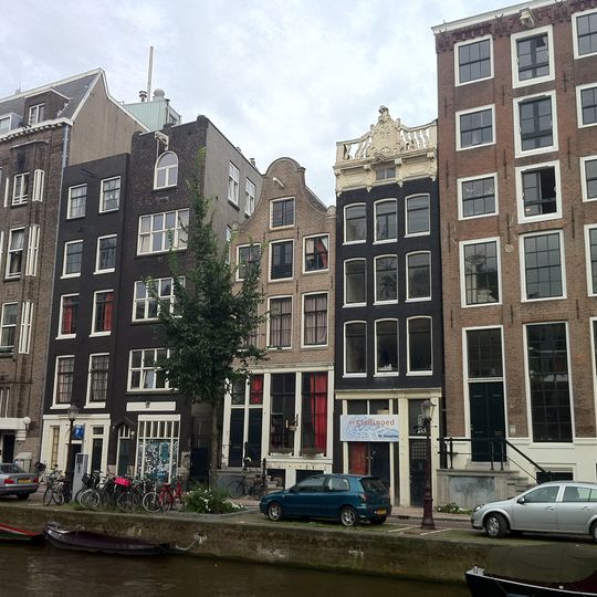 Pand met gevel onder rechte lijst met consoles, waarop attiek met kuifstuk