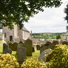 Bewcastle Roman fort, high cross shaft in St Cuthbert's churchyard, and Bew Castle medieval shell keep castle
