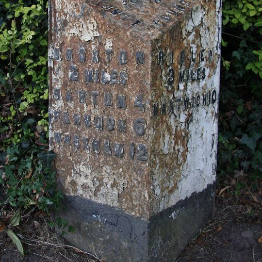 Milepost, opp. Bickerton Church, on cross roads