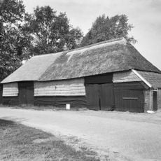 Schuurtje met wanden van stro en hout onder rieten schilddak