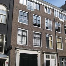 Voormalig koetshuis met gevel onder rechte lijst en deuromlijstingen