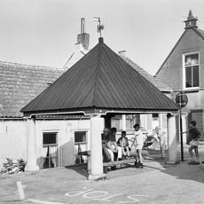 Visbank. Vier hardstenen zuilen met een houten tentdak