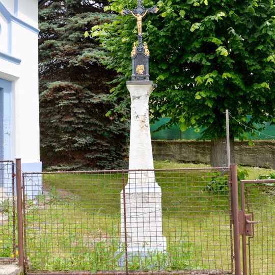 Wayside cross by chapel in Tojice