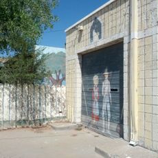 Man, woman, cat mural at closed gas-station