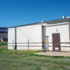 Cowboy and dog next to fence at Billy the Kid F.O.E.