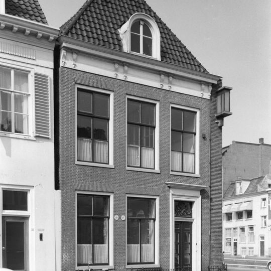 Pand met rechte kroonlijst met consoles onder zadeldak met voorschild, topschoorsteen en dakkapel