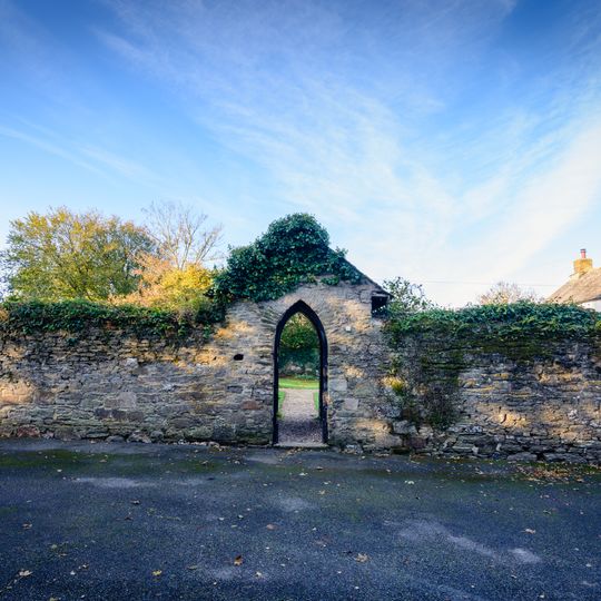 Garden wall and porches attached to front of Colan Barton Farmhouse