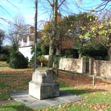Base of Village Cross, opposite The Grange