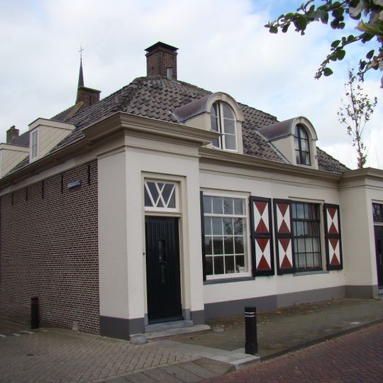 Sluiswachtershuis onder mansardedak, lage woning, centrale schoorsteen