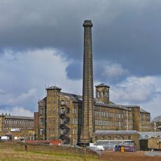 Mill chimney approximately 3 metres to south of principal mill buildings at black Dyke Mills
