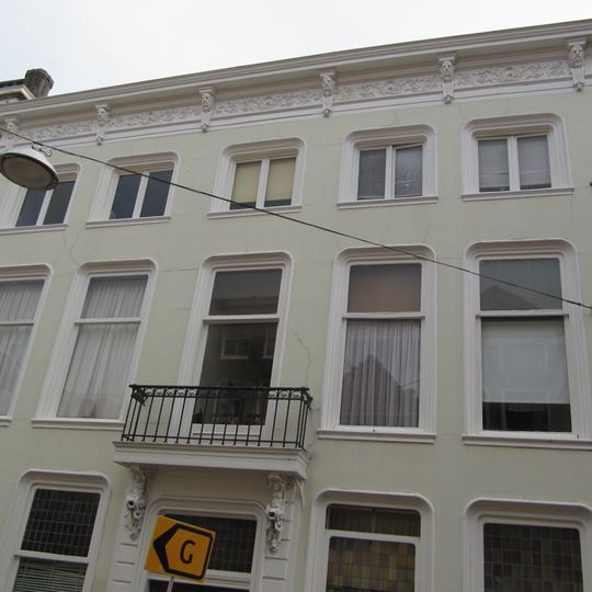 Pand met gepleisterde lijstgevel met rijk gesneden kroonlijst, en consoles