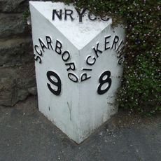 Milestone, Stainton, opp. thatched cottage