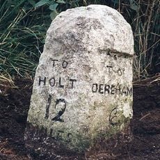 Milestone, opp. No.7, 10yds N of telephone box on E