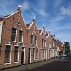 Rijtje van vier arbeiderswoningen in de stijl van de Neo-Hollandse Renaissance
