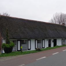 Deels gepleisterde boerderij, onder rieten zadeldak