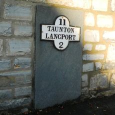 Milestone, centre of village, nr jct with B3168, beside war memorial